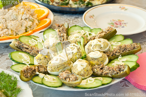 Image of Stuffed eggs and cucumbers. Banquet in the restaurant