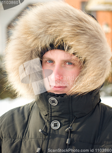 Image of Man in warm jacket with furry hood