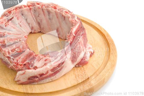 Image of Uncooked Pork ribs on round hardboard