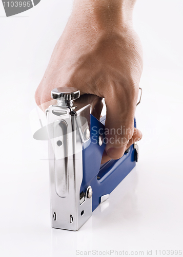 Image of Staple gun in man's arm over white