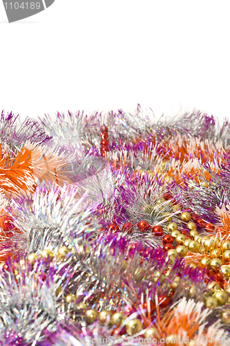 Image of Christmas greetings - colorful tinsel and beads