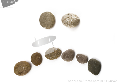 Image of Negative sad emoticon assembled of pebble