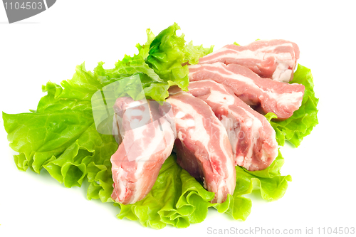 Image of Pork meat pieces on green salad Isolated