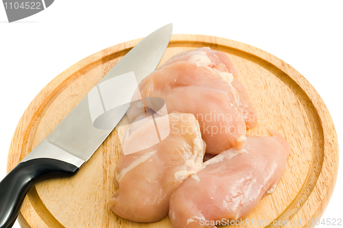 Image of Chicken fillet and knife on hardboard isolated