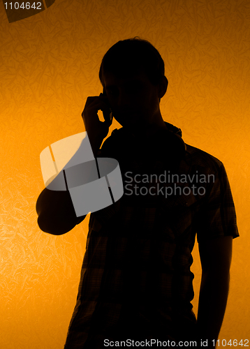 Image of Silhouette of man speak over the phone