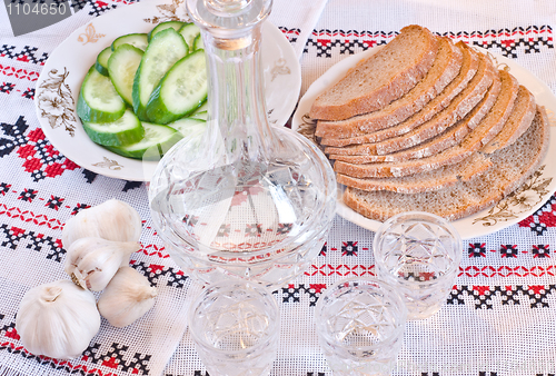 Image of Vodka, bread and sliced cucumber