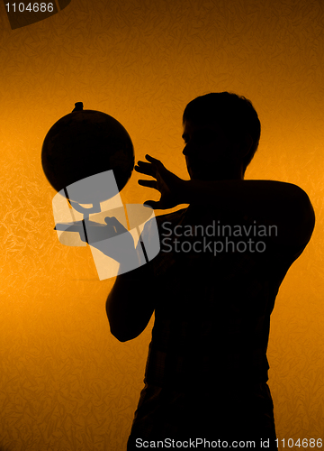 Image of Discover the world - silhouette of man holding globe
