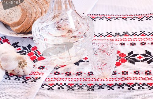 Image of Vodka in decanter, bread and garlic 