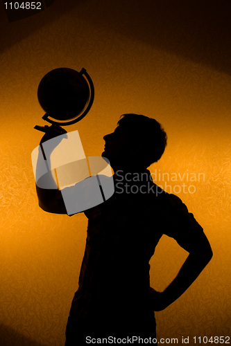 Image of Back light - silhouette of man holding globe