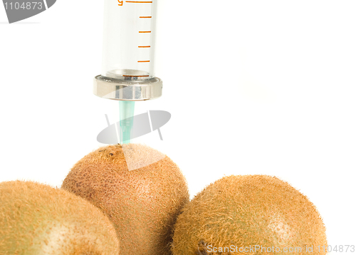 Image of GMO - kiwi with sticked aged syringe on white