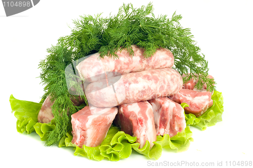 Image of Pork meat, Sausages and dill on green salad