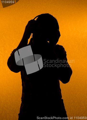 Image of Music fan. Silhouette of man with earphones