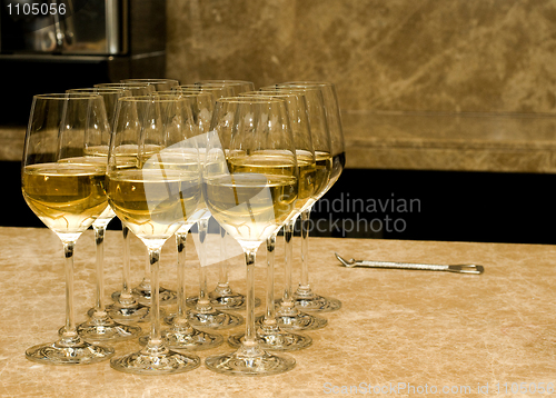 Image of Glasses with white wine and opener on marble