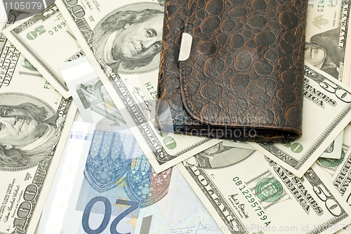 Image of Wealth - old wallet, US dollars and euro