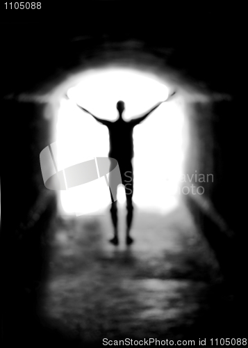 Image of Human silhouette against the light of tunnel exit (shallow DOF)