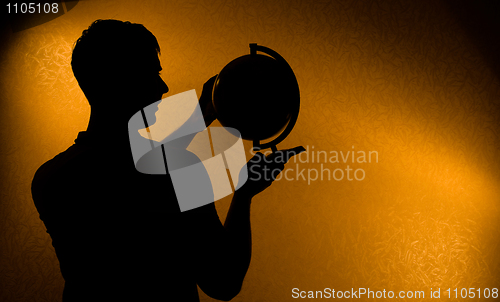 Image of Silhouette of man holding globe