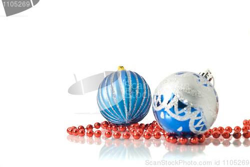 Image of Christmas comes -  two blue balls and red beads