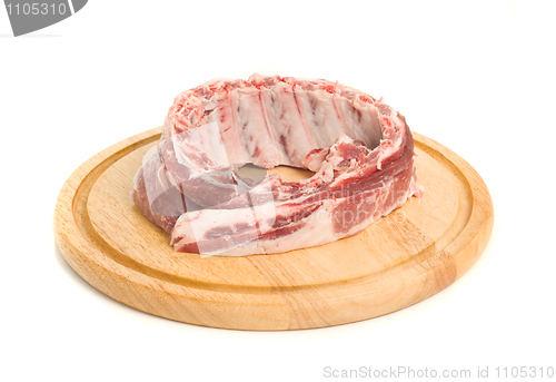 Image of Uncooked Pork meat on round hardboard 