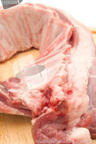 Image of Closeup of Uncooked Pork ribs on hardboard 
