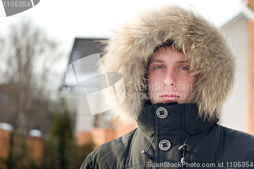 Image of Winter time - man in warm jacket with furry hood