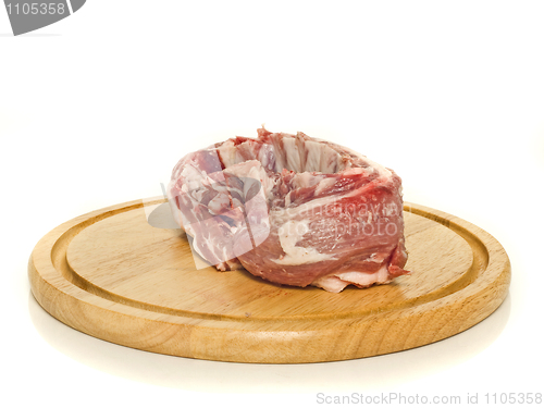 Image of Raw meat on round hardboard