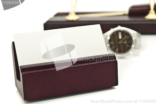 Image of Card holder with blank white business card, watch and pens