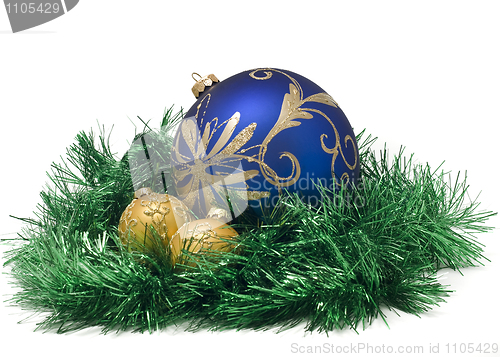 Image of Three Beautiful Christmas or New Year balls in green tinsel 