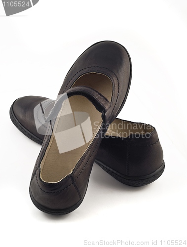 Image of Women's black leather shoes over white