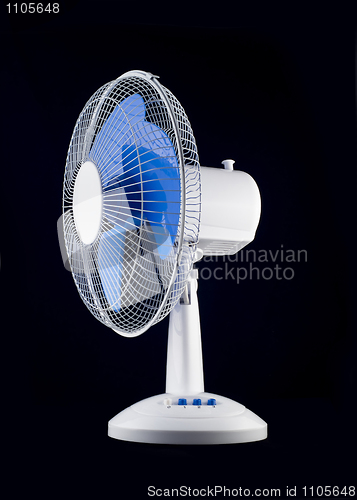 Image of White cooling fan over black