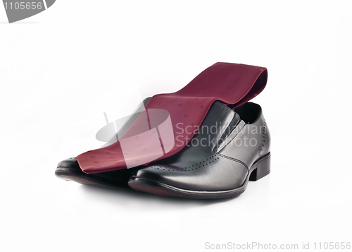 Image of Tie and a Pair of man's classic leather shoes isolated over whit