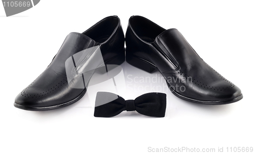 Image of Black bow and men's classic shoes isolated