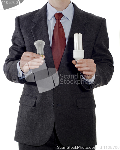 Image of Businessman with old and energy-saving light bulbs