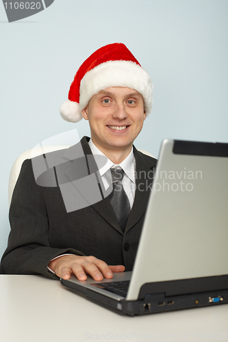 Image of Man in festive Christmas mood with laptop