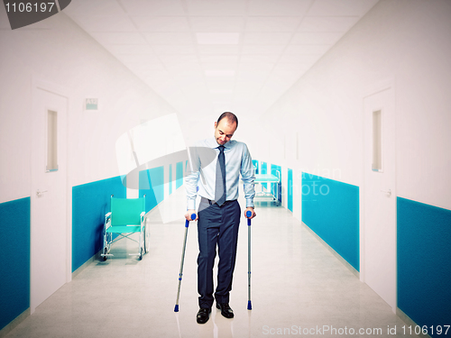 Image of man with crutch in hospital