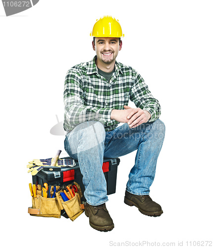 Image of young manual worker and toolbox