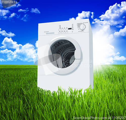 Image of washing machine and green  field 