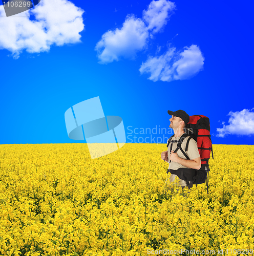 Image of happy backpackers in flowers field