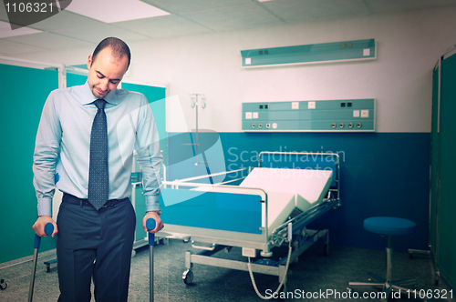 Image of man with crutch in hospital