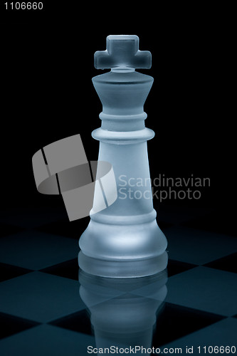Image of Macro shot of glass chess king against a black background