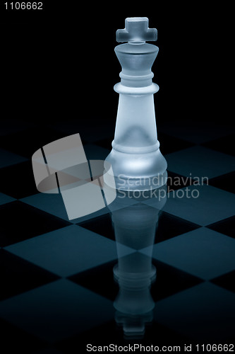 Image of Macro shot of glass chess king against a black background