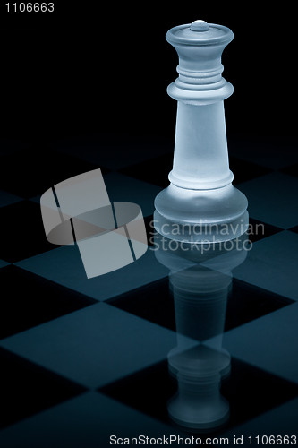 Image of Macro shot of glass chess queen against a black background