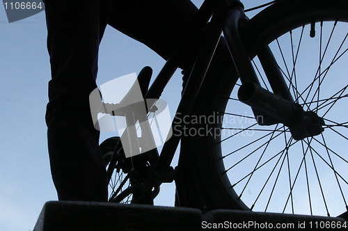 Image of Man standing with a bmx bike