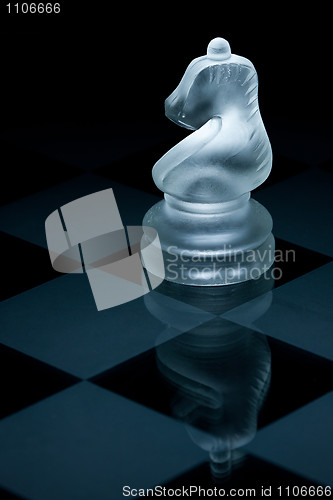 Image of Macro shot of glass chess knight against a black background