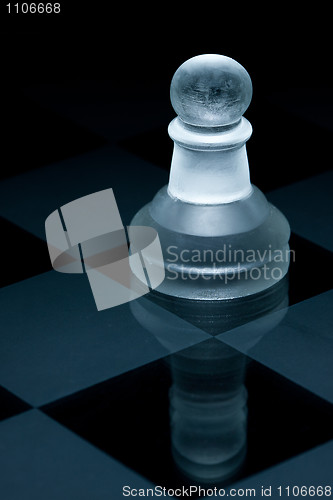 Image of Macro shot of glass chess pawn against a black background