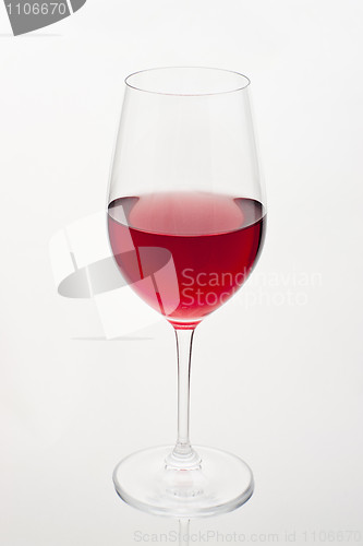 Image of Glass of red wine in soft white light