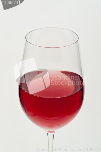 Image of Glass of red wine in soft white light