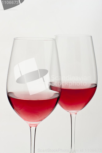 Image of Two glasses of red wine in soft white light