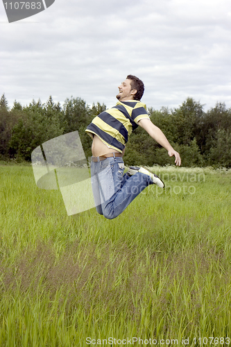 Image of man jumps on a grass