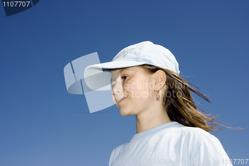 Image of The smiling girl against a dark blue clear sky