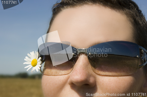 Image of The girl in sunglasses